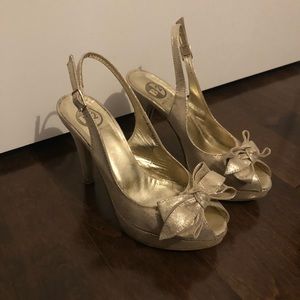 Gold peep-toe heels with bow